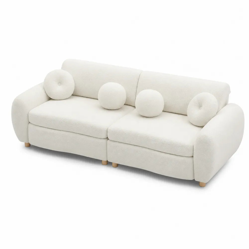 Divano modulare in tessuto bouclé bianco con cuscini decorativi e piedi in legno