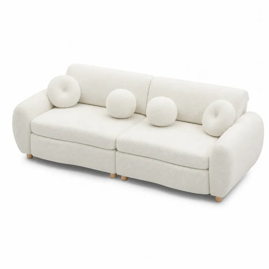 Divano modulare in tessuto bouclé bianco con cuscini decorativi e piedi in legno